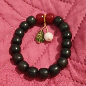 Elegant Black Beaded Bracelet with Red and Green Accents